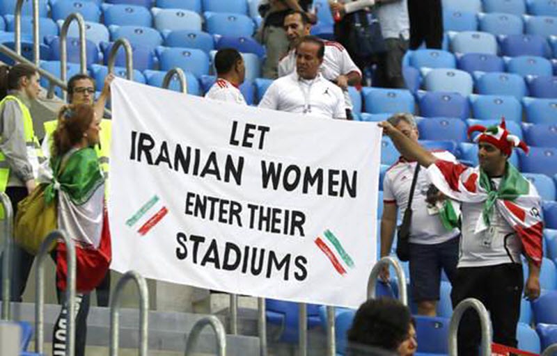 Iranian supporters at the team’s first World Cup match took the opportunity to protest the Iranian Regime’s sexist ban on women attending football matches in their own country.
