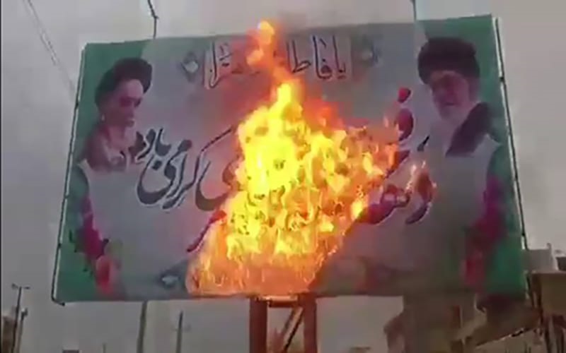 Iranian Youths burn Iran's supreme leader's poster